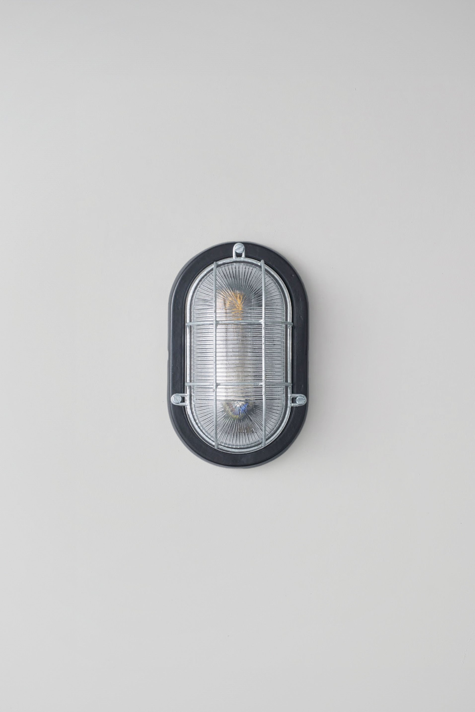 OBTC Product Image: Oval Aluminium Bulkhead for GLS 7003, Black, Prismatic Glass, Davey Lighting