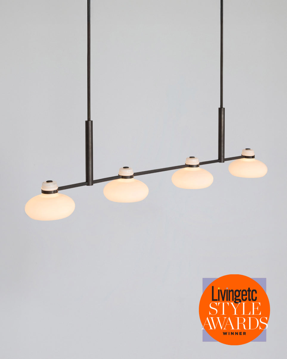 Modern pendant light with glass shades on a gray background, featuring Livingetc Style Awards logo.