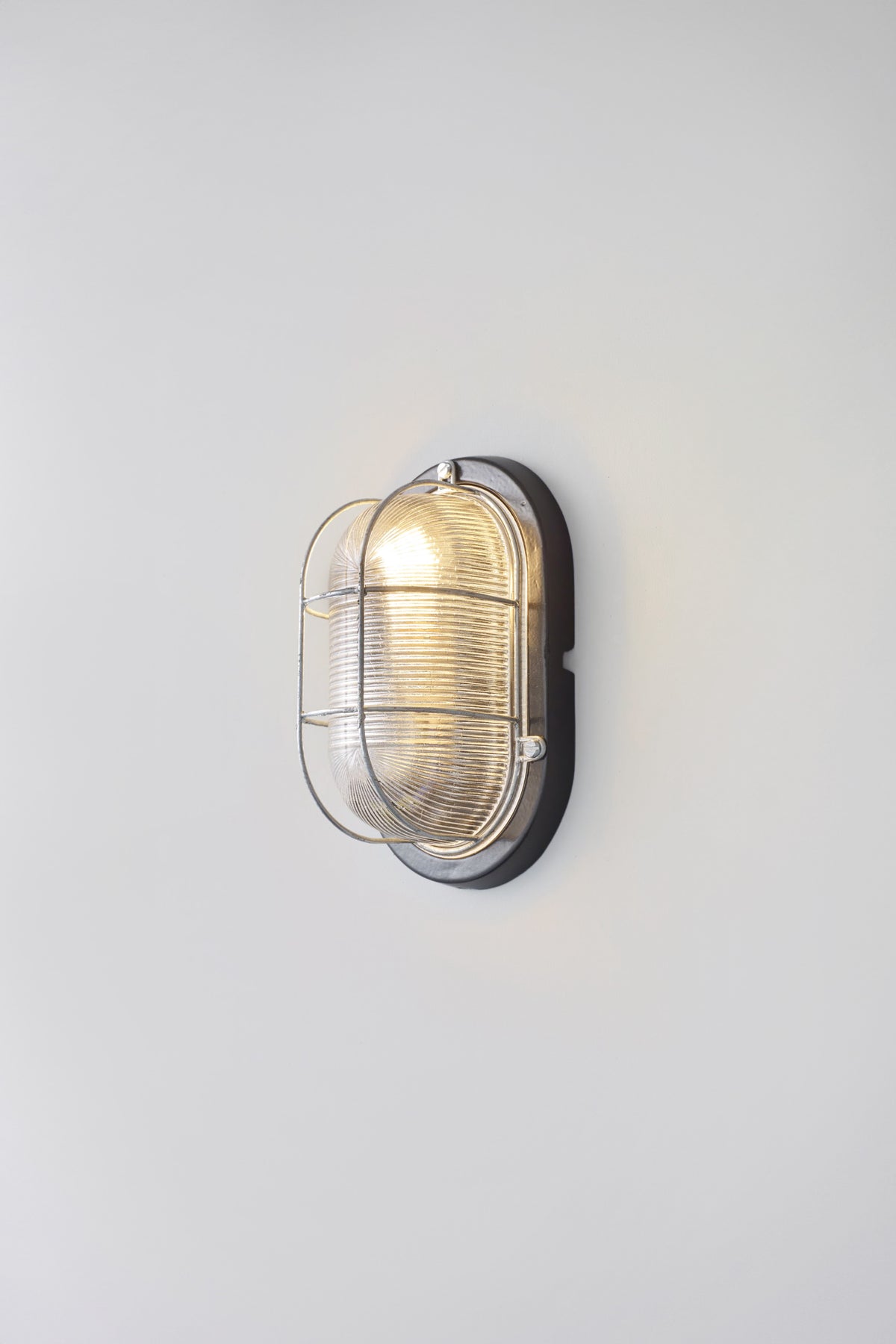 OBTC Product Image, Light On: Oval Aluminium Bulkhead for GLS 7003, Black, Prismatic Glass, Davey Lighting Range
