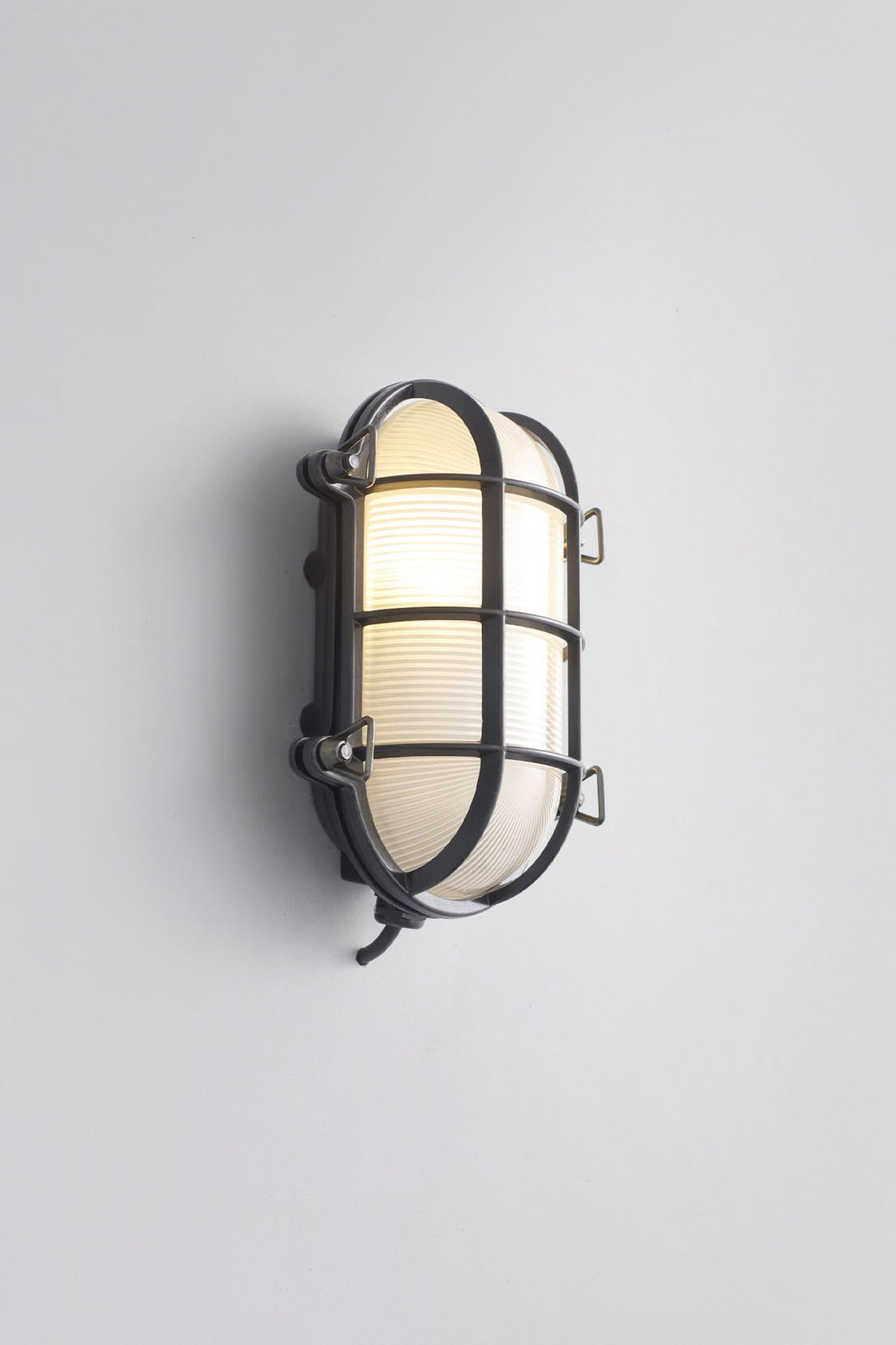 OBTC Product Image, Light On: Oval Brass Bulkhead 7035, Weathered Brass, Frosted Prismatic Glass, Davey Lighting Range
