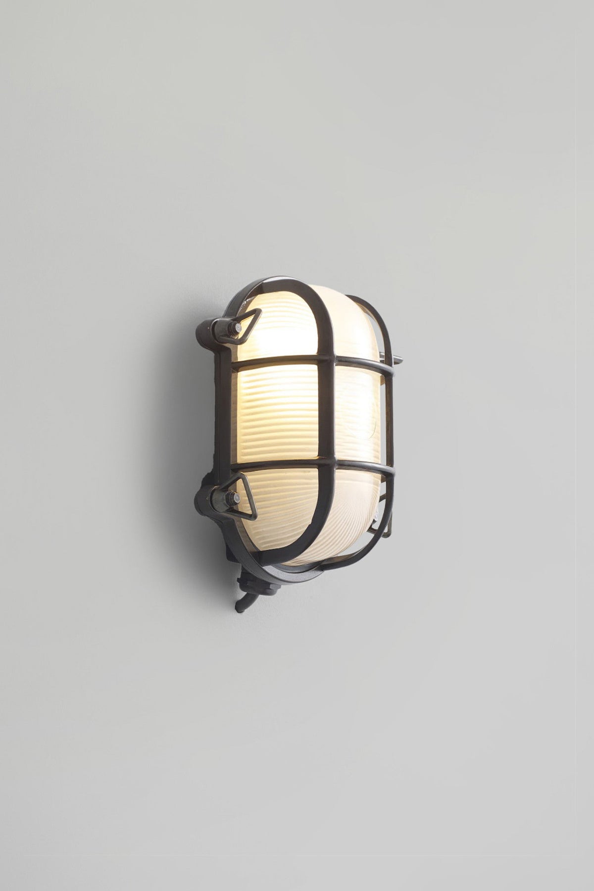 OBTC Product Image, Light On: Oval Brass Bulkhead 7036, Weathered Brass, Frosted Prismatic Glass, Davey Lighting Range