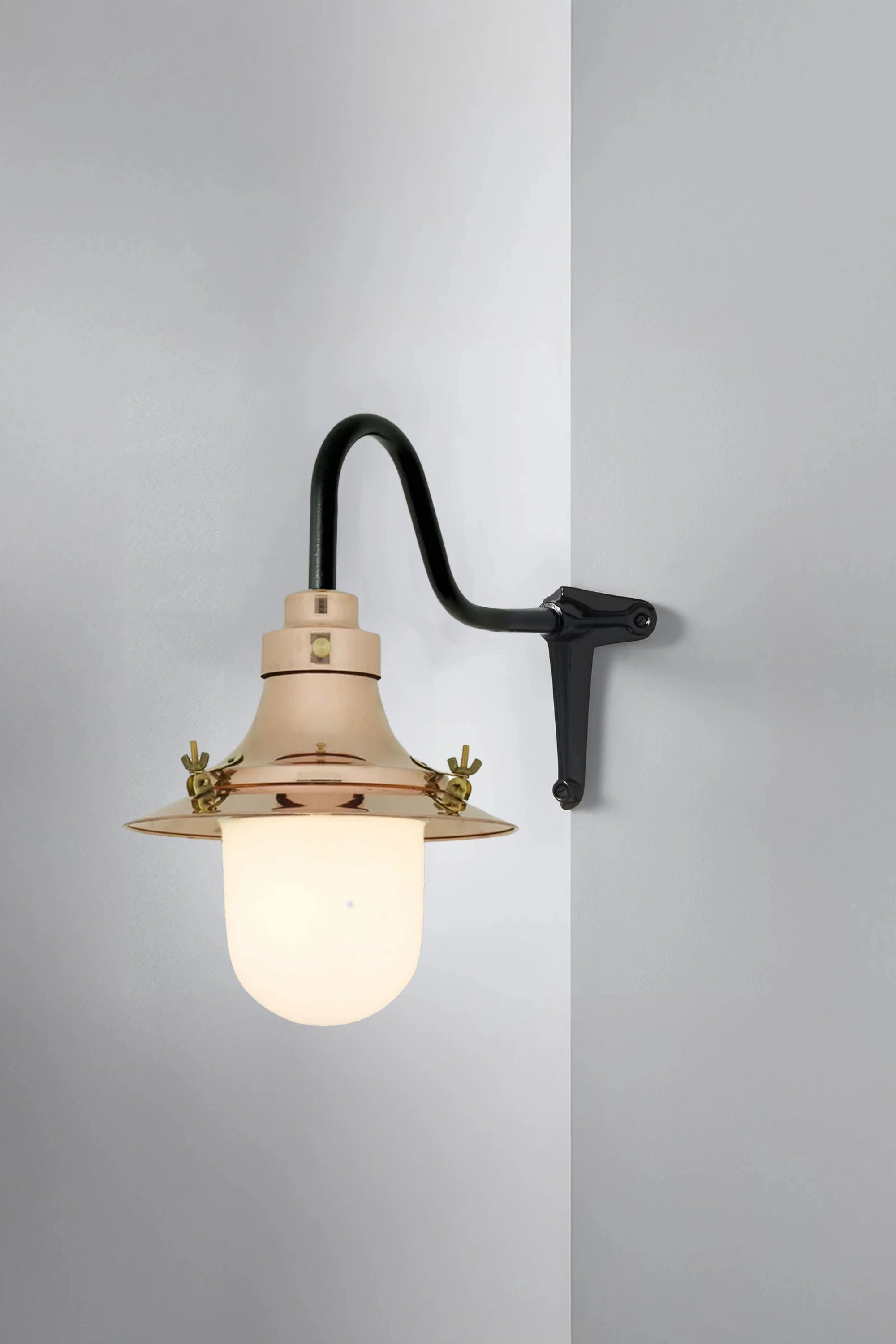 Vintage-style wall lamp with a light bulb on a gray background