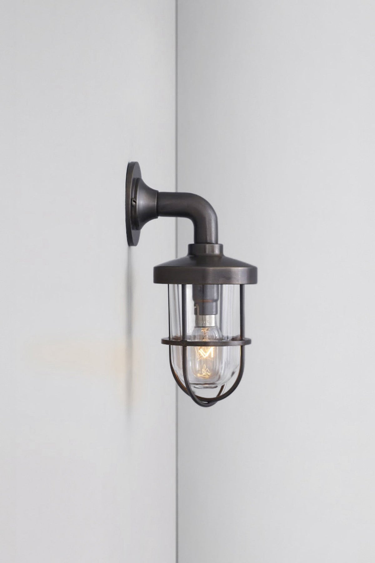 OBTC Product Image, Light On: Miniature Weatherproof Ship's Well Glass Light 7207, Weathered Brass, Clear Glass, Davey Lighting Range