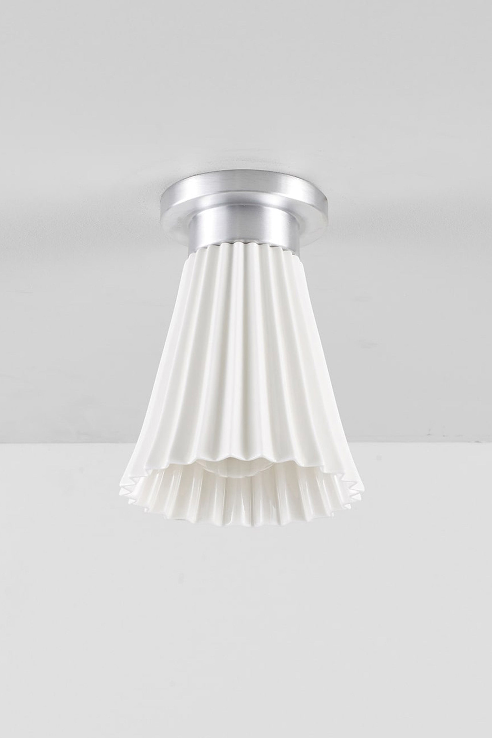 Hector Pleat medium ceiling light with a bone china shade and aluminium fittings, shown unlit.